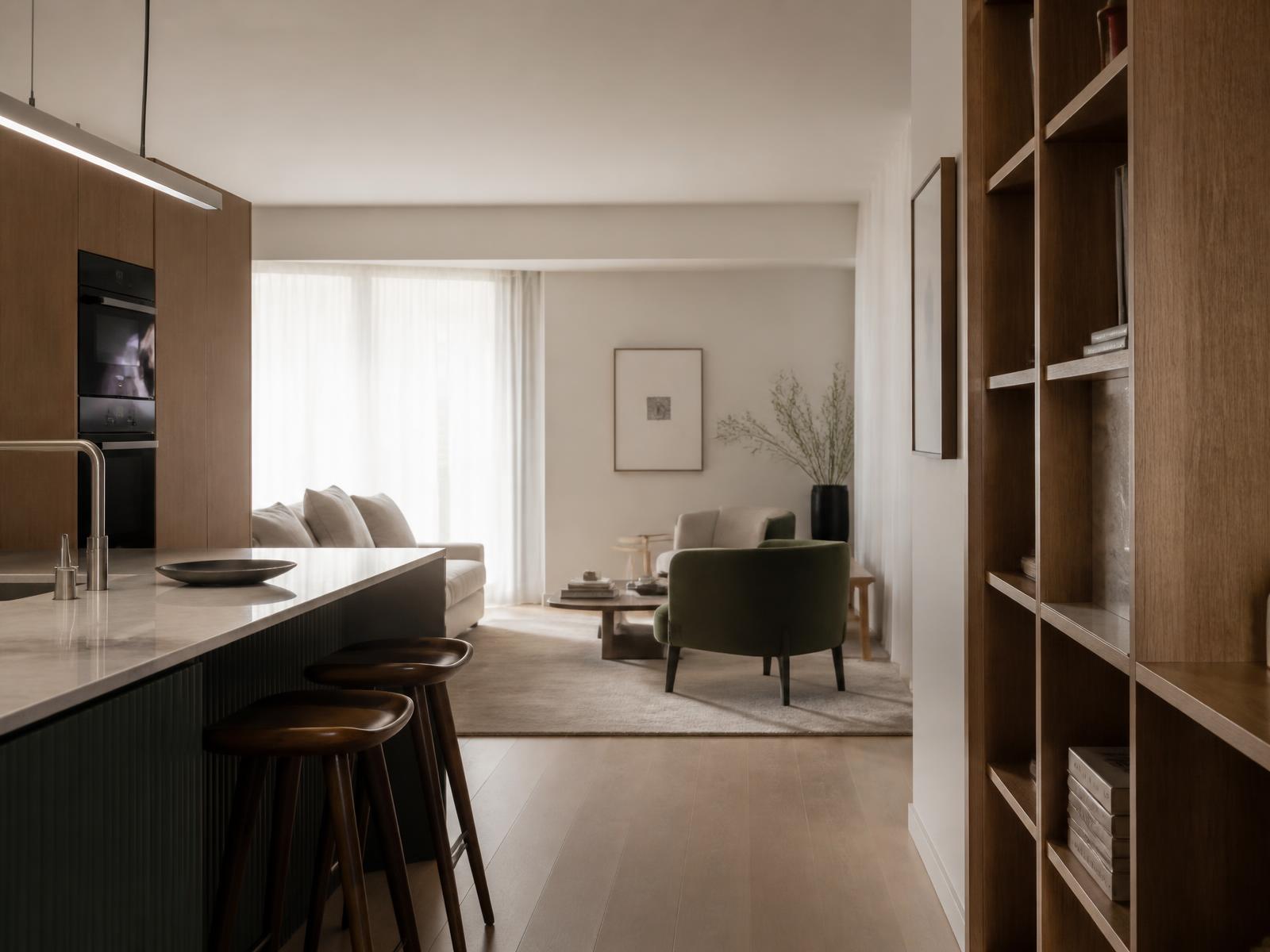 Renovated Sydney apartment interior with warm timber joinery and stone benchtop